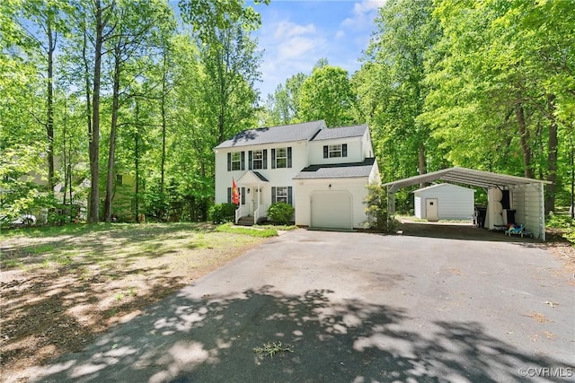 view of front of house with a detached carport and driveway