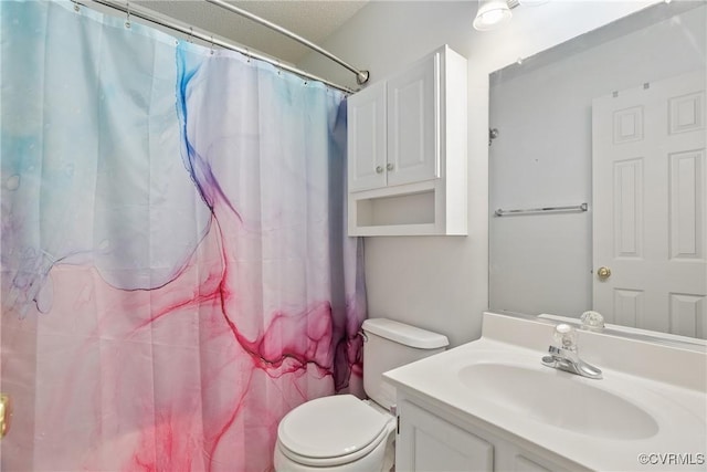 bathroom with toilet, curtained shower, and vanity