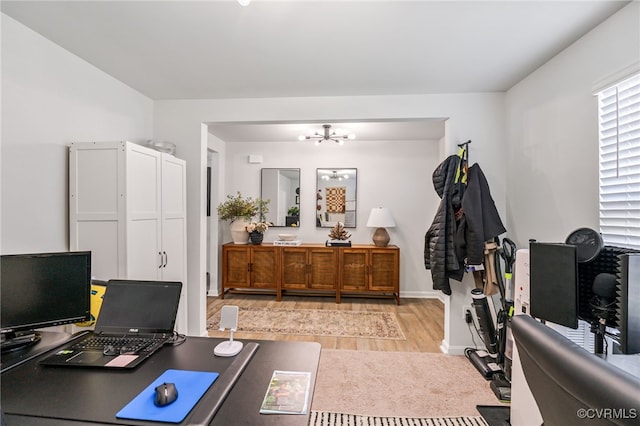 office with a chandelier, wood finished floors, and baseboards