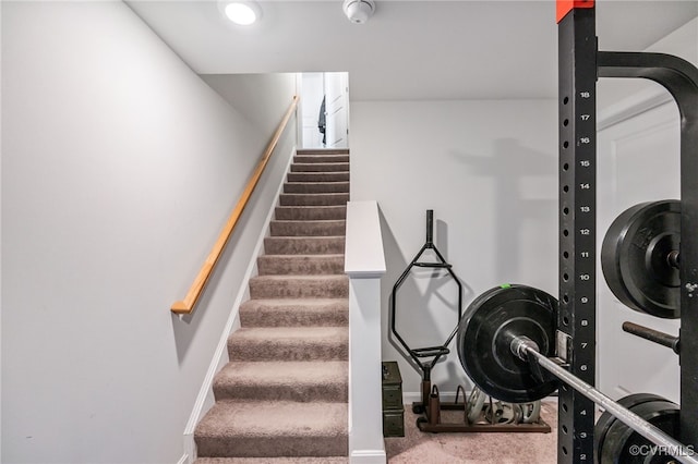 staircase with baseboards and carpet flooring