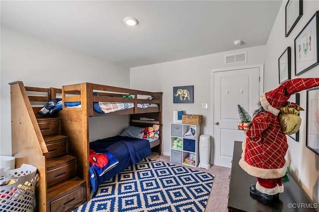 carpeted bedroom featuring visible vents