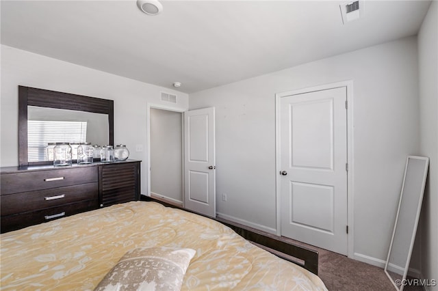 carpeted bedroom with visible vents and baseboards