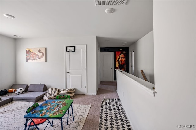 carpeted living area featuring baseboards and visible vents