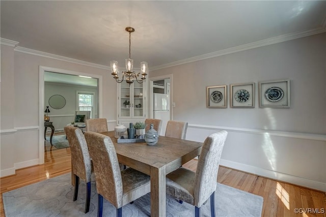 12665 Petersburg St, Chester, VA 23831 - dining area featuring a chandelier, light wood-type flooring, baseboards, and ornamental molding