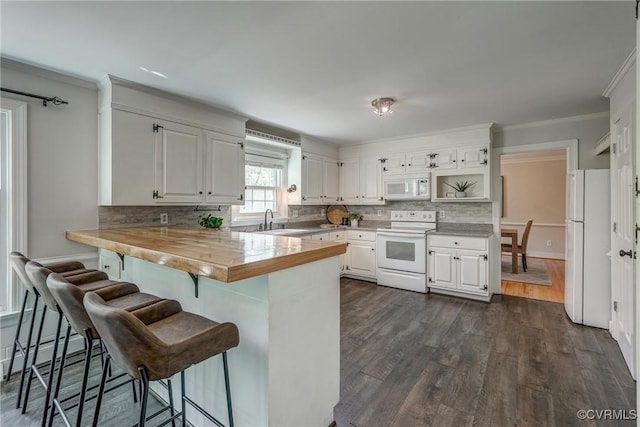 12665 Petersburg St, Chester, VA 23831 - kitchen with white appliances, a peninsula, backsplash, a kitchen bar, and a sink