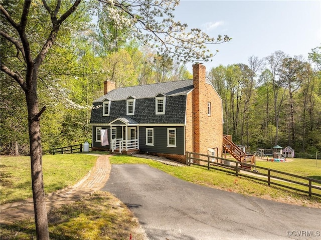 12665 Petersburg St, Chester, VA 23831 - dutch colonial with a front yard, a chimney, a gambrel roof, fence private yard, and roof with shingles