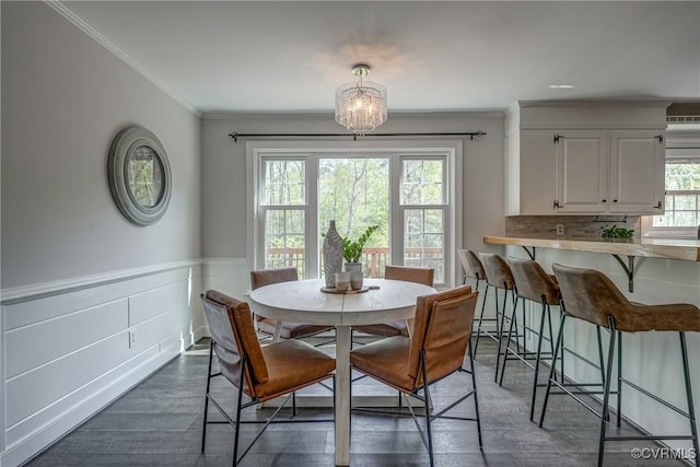 12665 Petersburg St, Chester, VA 23831 - dining space featuring dark wood-style flooring, wainscoting, an inviting chandelier, and crown molding