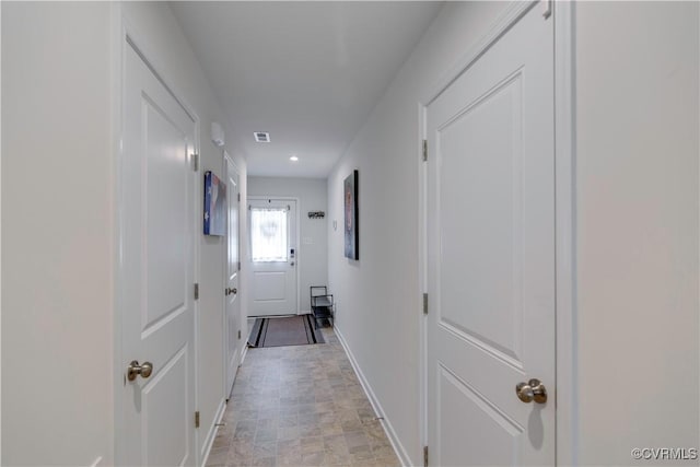 corridor featuring visible vents, recessed lighting, and baseboards
