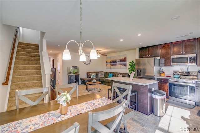 dining area with recessed lighting and stairs
