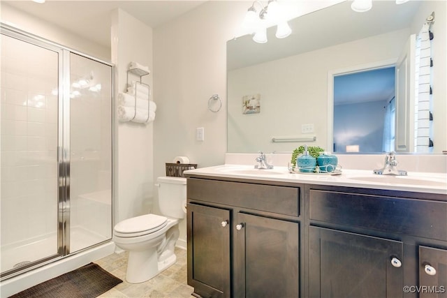 full bath featuring a stall shower, toilet, and a sink