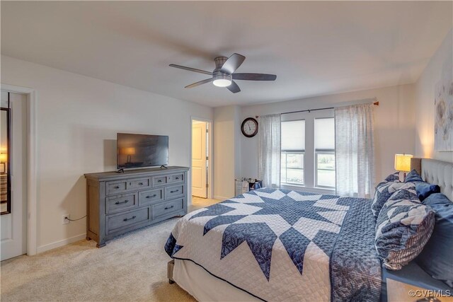 bedroom featuring baseboards, light carpet, and ceiling fan