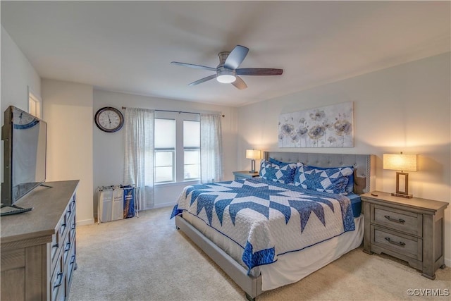 bedroom with light colored carpet, a ceiling fan, and baseboards