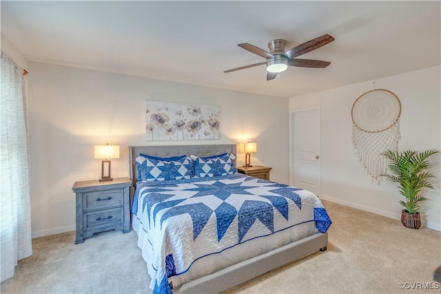 bedroom with ceiling fan, light colored carpet, and baseboards