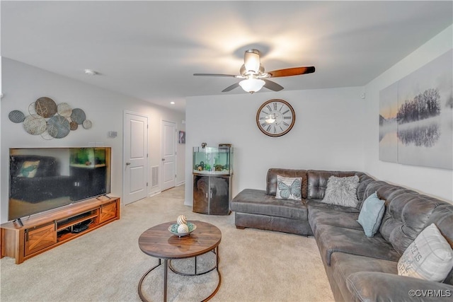 carpeted living room with a ceiling fan