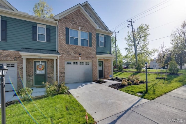 view of front of home with a front yard, driveway, a garage, and brick siding