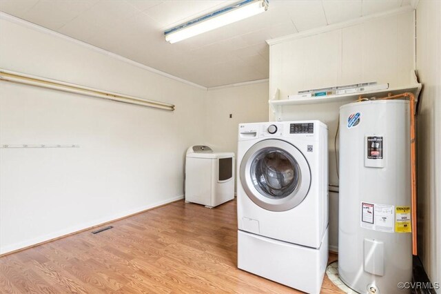 627 Sedgefield Dr, Newport News, VA 23605 - laundry room with electric water heater, ornamental molding, light wood-style flooring, laundry area, and washing machine and clothes dryer