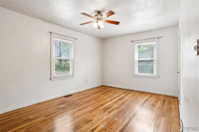 627 Sedgefield Dr, Newport News, VA 23605 - unfurnished room with baseboards, a ceiling fan, light wood-style floors, and a healthy amount of sunlight