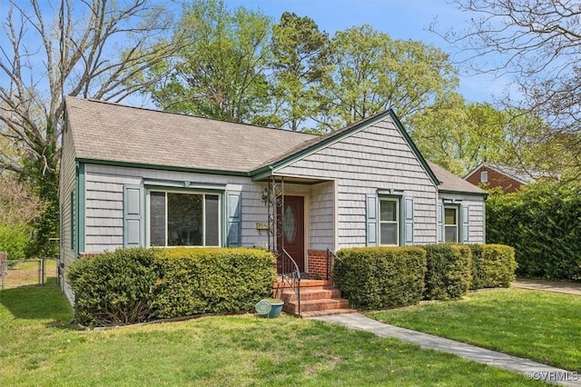 627 Sedgefield Dr, Newport News, VA 23605 - view of front facade with a shingled roof, fence, and a front lawn