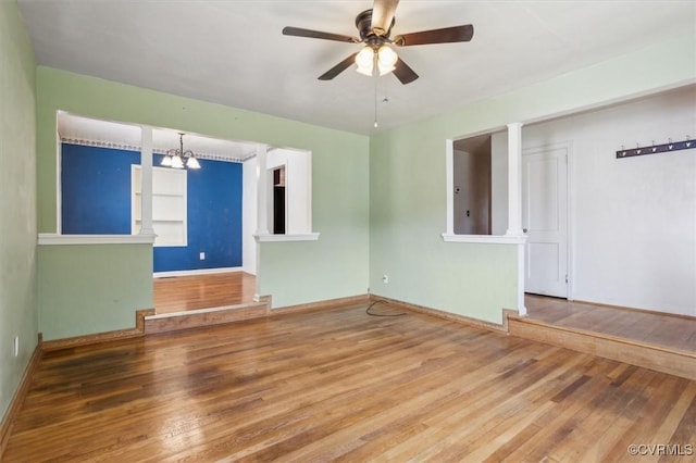 627 Sedgefield Dr, Newport News, VA 23605 - spare room featuring built in shelves, ceiling fan with notable chandelier, baseboards, and wood finished floors