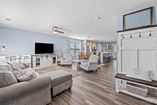 living area featuring visible vents, a ceiling fan, wood finished floors, and recessed lighting