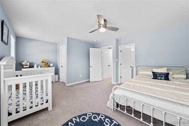 carpeted bedroom with a ceiling fan and baseboards