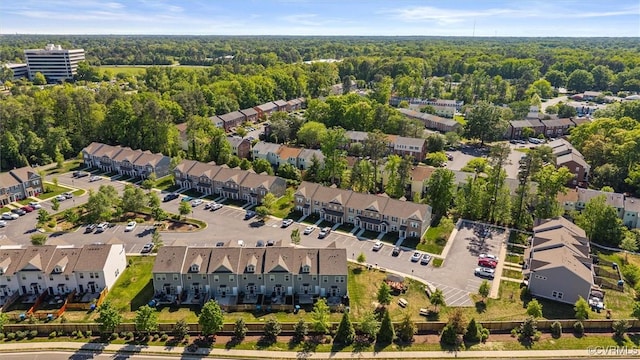 drone / aerial view featuring a forest view and a residential view