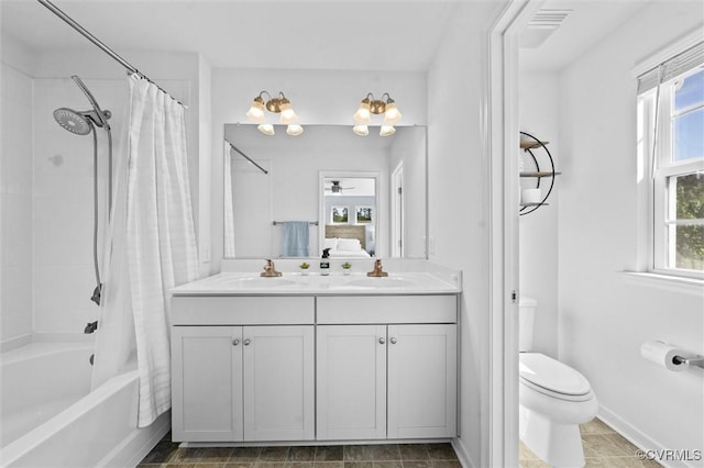 bathroom featuring ceiling fan, shower / bath combination with curtain, vanity, baseboards, and toilet