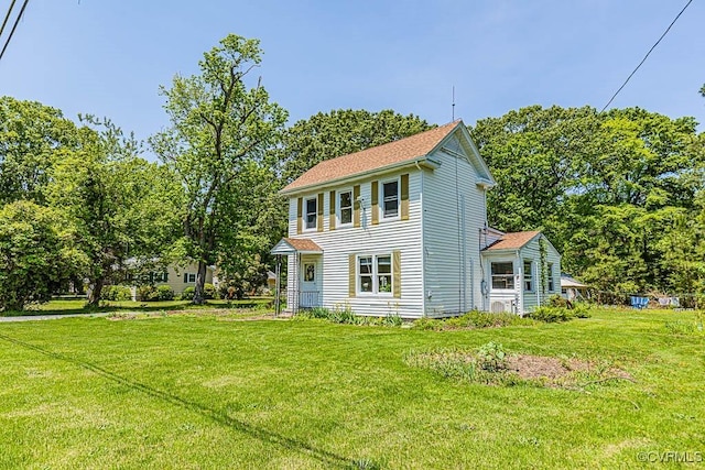 view of side of home with a yard