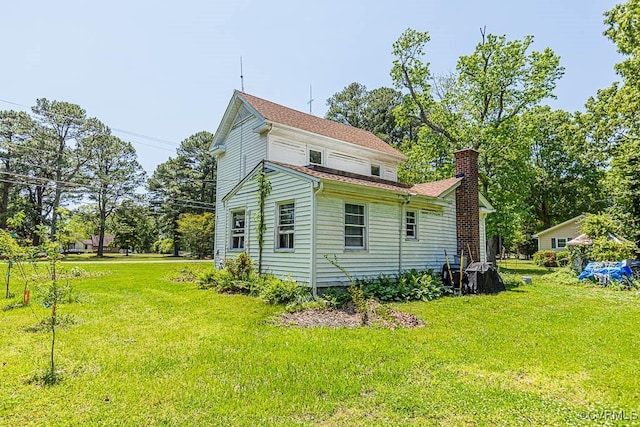 view of property exterior featuring a lawn and a chimney