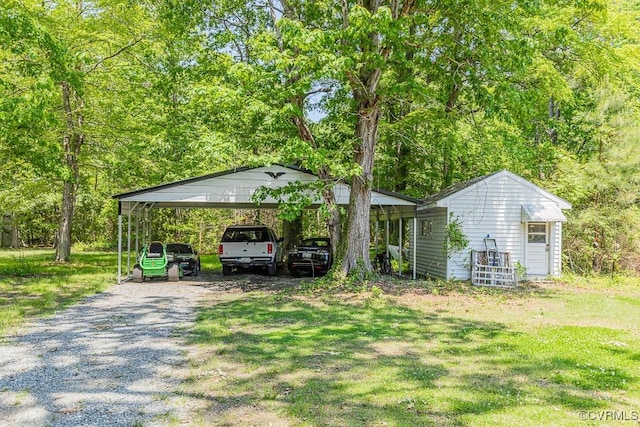 view of vehicle parking with gravel driveway and a detached carport