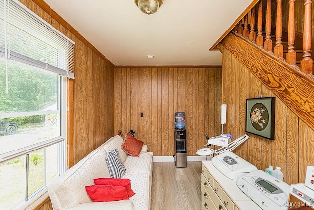 bathroom featuring plenty of natural light, wooden walls, and wood finished floors