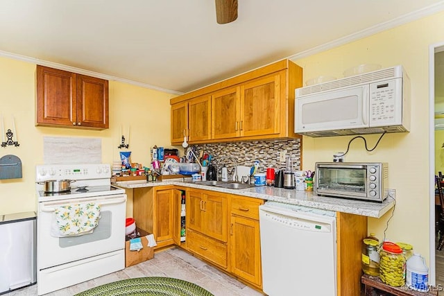 kitchen featuring backsplash, crown molding, a sink, and white appliances