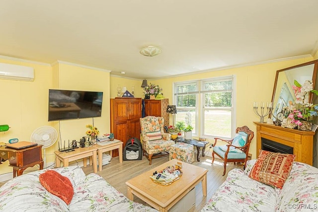 living room featuring crown molding, a fireplace, wood finished floors, and a wall unit AC