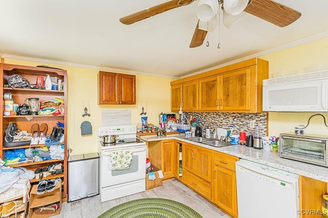 kitchen featuring ornamental molding, white appliances, ceiling fan, decorative backsplash, and a sink