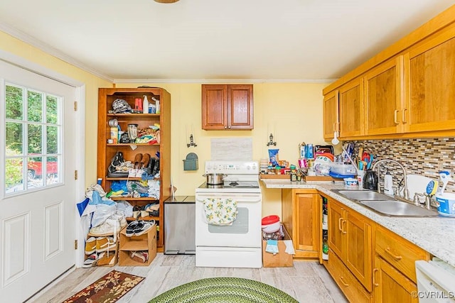 kitchen with white appliances, brown cabinetry, tasteful backsplash, ornamental molding, and a sink