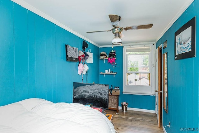 bedroom featuring ornamental molding, ceiling fan, wood finished floors, and baseboards