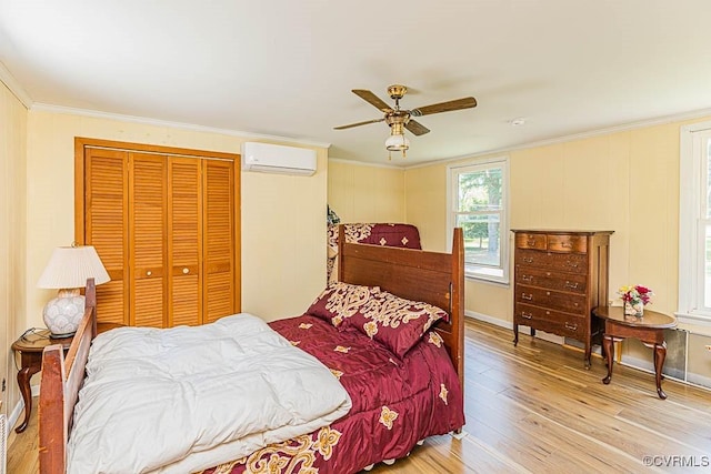 bedroom with a wall mounted AC, light wood-style floors, a closet, and ornamental molding