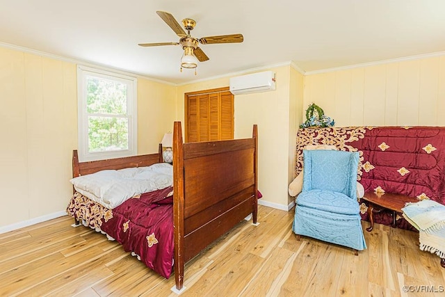 bedroom with ornamental molding, a ceiling fan, a wall mounted AC, and hardwood / wood-style flooring