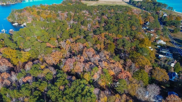 aerial view featuring a water view and a wooded view