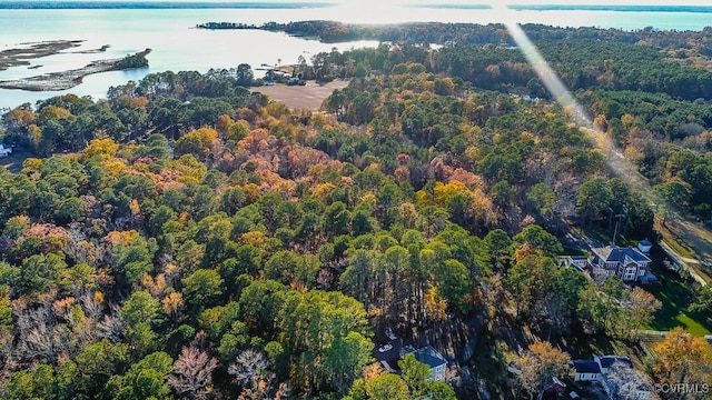 aerial view with a forest view and a water view
