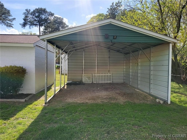 view of outdoor structure featuring a detached carport and driveway