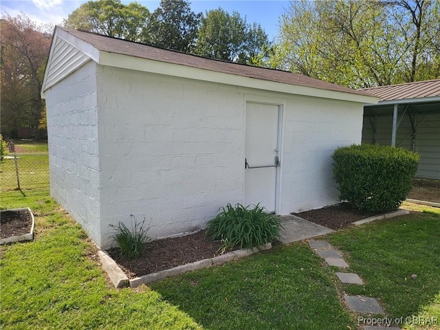 view of outbuilding with fence and an outbuilding
