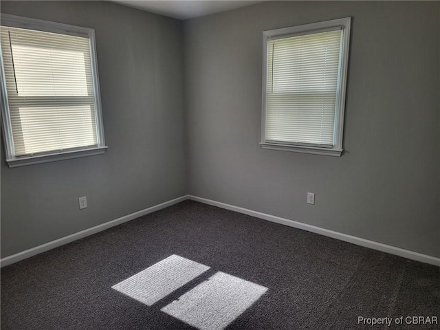 unfurnished room with baseboards and carpet floors