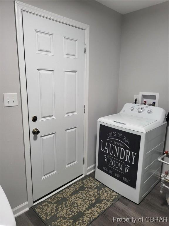 washroom featuring washer / clothes dryer, laundry area, dark wood-type flooring, and baseboards
