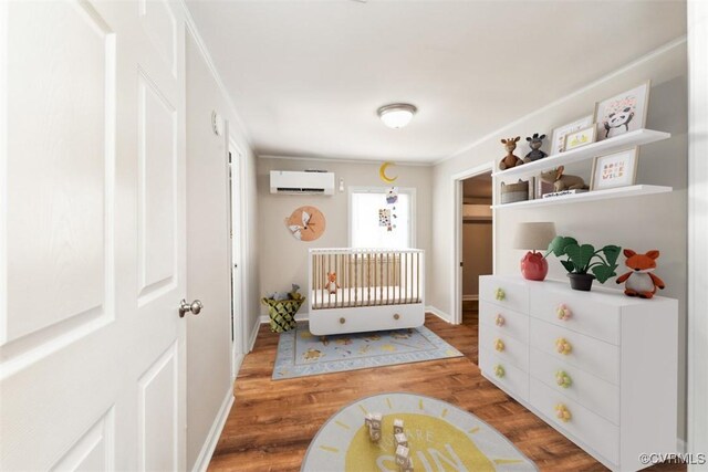 932 Eastern View Rd, King & Queen, VA 23148 - bedroom with a wall mounted air conditioner, baseboards, and wood finished floors