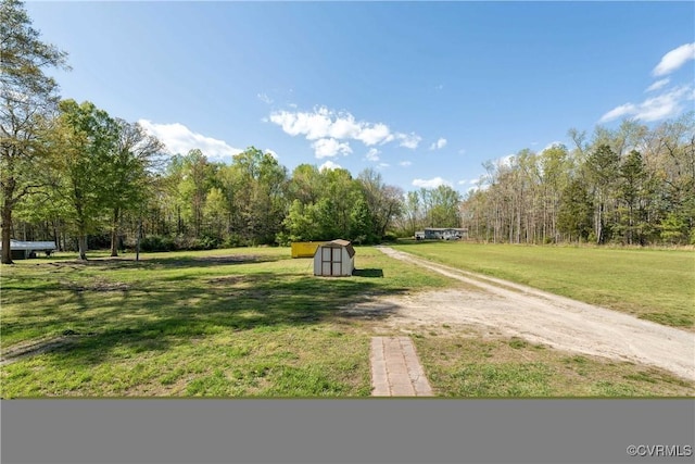 932 Eastern View Rd, King & Queen, VA 23148 - view of home's community with a lawn, dirt driveway, a storage unit, and an outbuilding