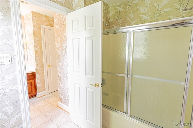bathroom featuring tile patterned flooring, shower / bath combination with glass door, and wallpapered walls
