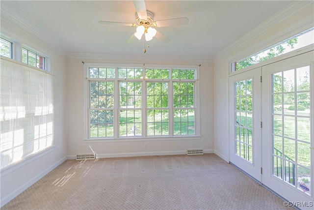 unfurnished sunroom with visible vents, a healthy amount of sunlight, and french doors