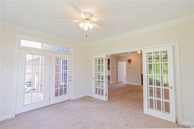 unfurnished room featuring baseboards, ornamental molding, and french doors