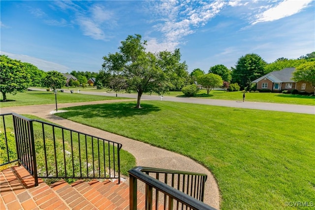 view of property's community with a lawn